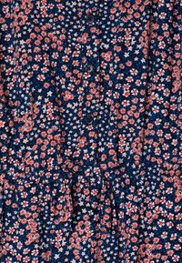 Floral dress in navy blue with red and white flower patterns. Features buttons down the front and a drawstring waist for adjustment.