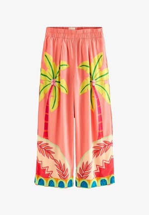 Pink culottes with palm tree and leaf patterns. Features an elastic waistband and contrasting borders with geometric accents. Lightweight fabric.