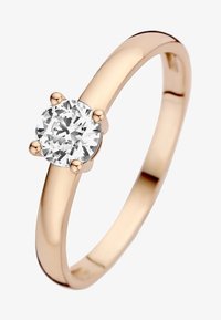 Goldring mit einem glatten, polierten Band und einem runden, klaren Diamanten, der von vier Krappen gehalten wird. Einfaches Design, klassische runde Form.
