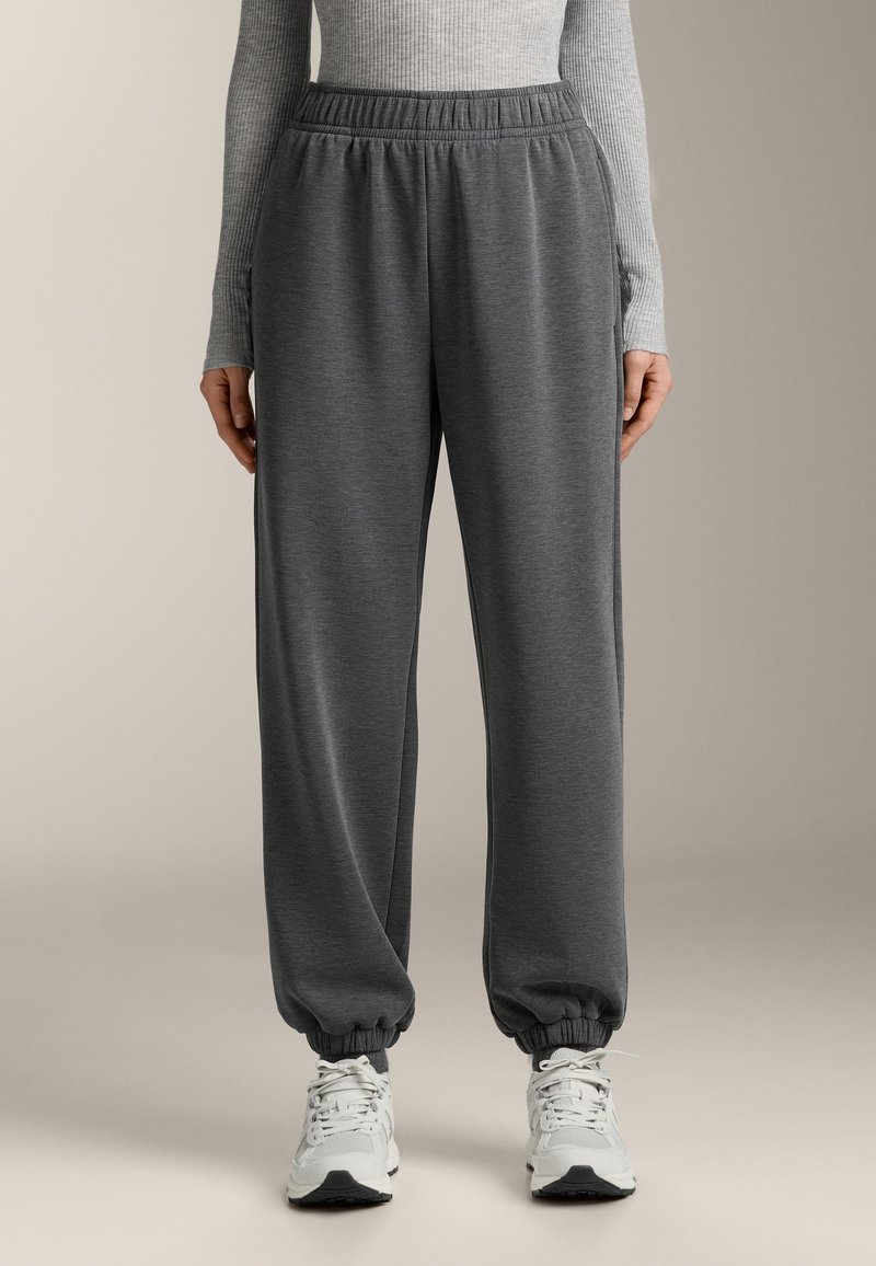 Szürke melegítőalsó rugalmas derékpánttal, szűkített szárvégekkel és oldalzsebekkel. Puha, texturált anyagból készült, alkalmi viselésre alkalmas.