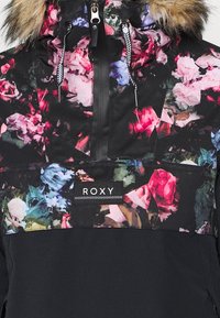 Giacca con motivo floreale su base nera, dotata di cappuccio foderato in pelliccia, cordini regolabili e logo Roxy sul davanti.