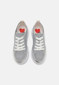Grey mesh sneakers with white laces, featuring a smooth white sole and a red heart graphic on the insole with "LOVE" text.