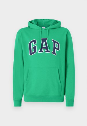 Green hoodie featuring a kangaroo pocket and drawstring hood. Large "GAP" logo in navy outlined in white across the chest. Cotton blend material.