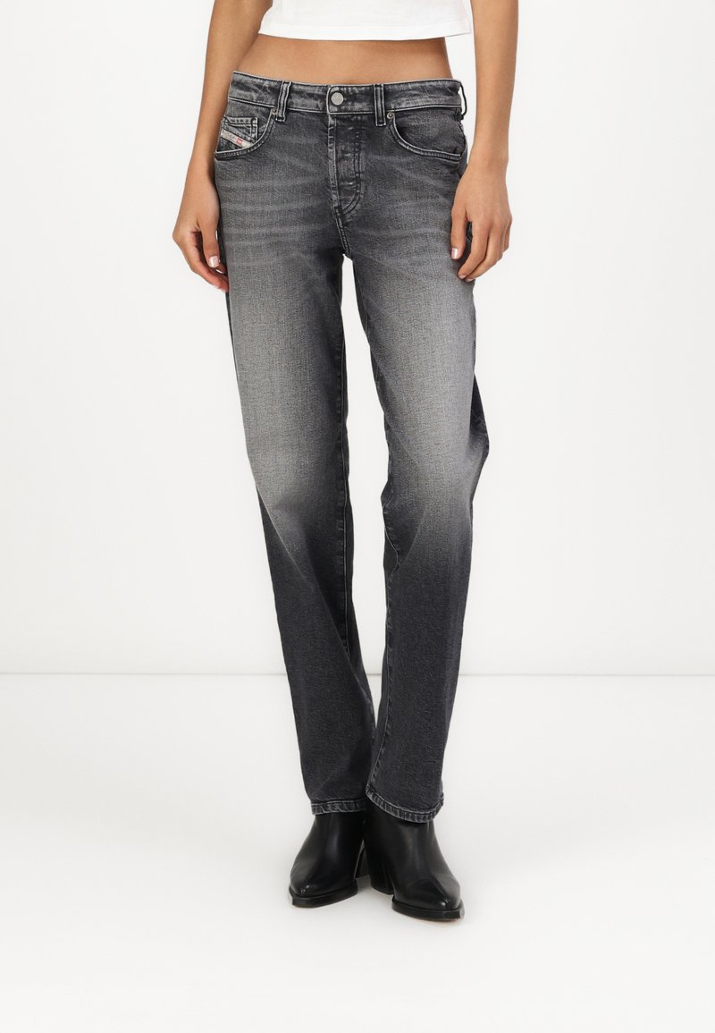 Gray denim jeans with a straight-leg cut, featuring a subtle fading effect, five pockets, and contrasting stitching details.