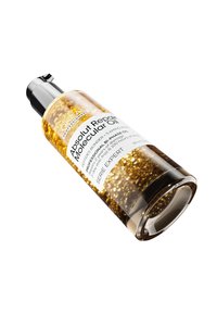 Bi-fase hårolje i en klar glassflaske med svart pumpehette. Oljen er gyllen med bobler, merket "Absolut Repair Molecular Oil."