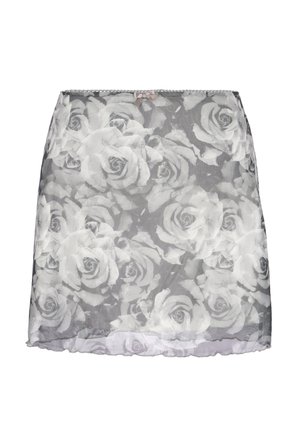 Jupe transparente grise avec de grands motifs de roses blanches et un petit nœud beige à la taille, longueur au-dessus du genou.