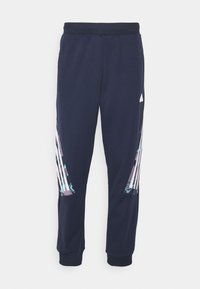 Marina blå träningsbyxor med ribbstickad midja och muddar. Har tre vita ränder och färgglada geometriska mönster på sidorna.