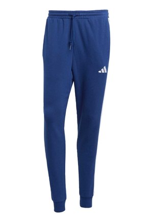 Blue tapered sweatpants with elastic waistband, drawstring, cuffed ankles, and a small white Adidas logo on the upper left thigh.