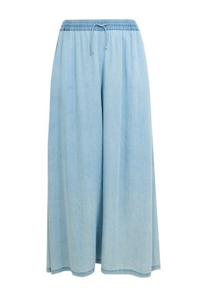 Pantalon denim large bleu clair avec ceinture élastique et cordon de serrage, conçu pour un usage décontracté.