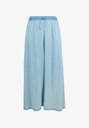Pantalon denim large bleu clair avec ceinture élastique et cordon de serrage, conçu pour un usage décontracté.