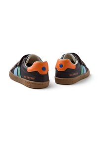 Sneakers con esterno in pelle marrone, strisce blu e verdi, dettagli arancioni sul tallone, suola in gomma e testo "HAVE A NICE DAY!".