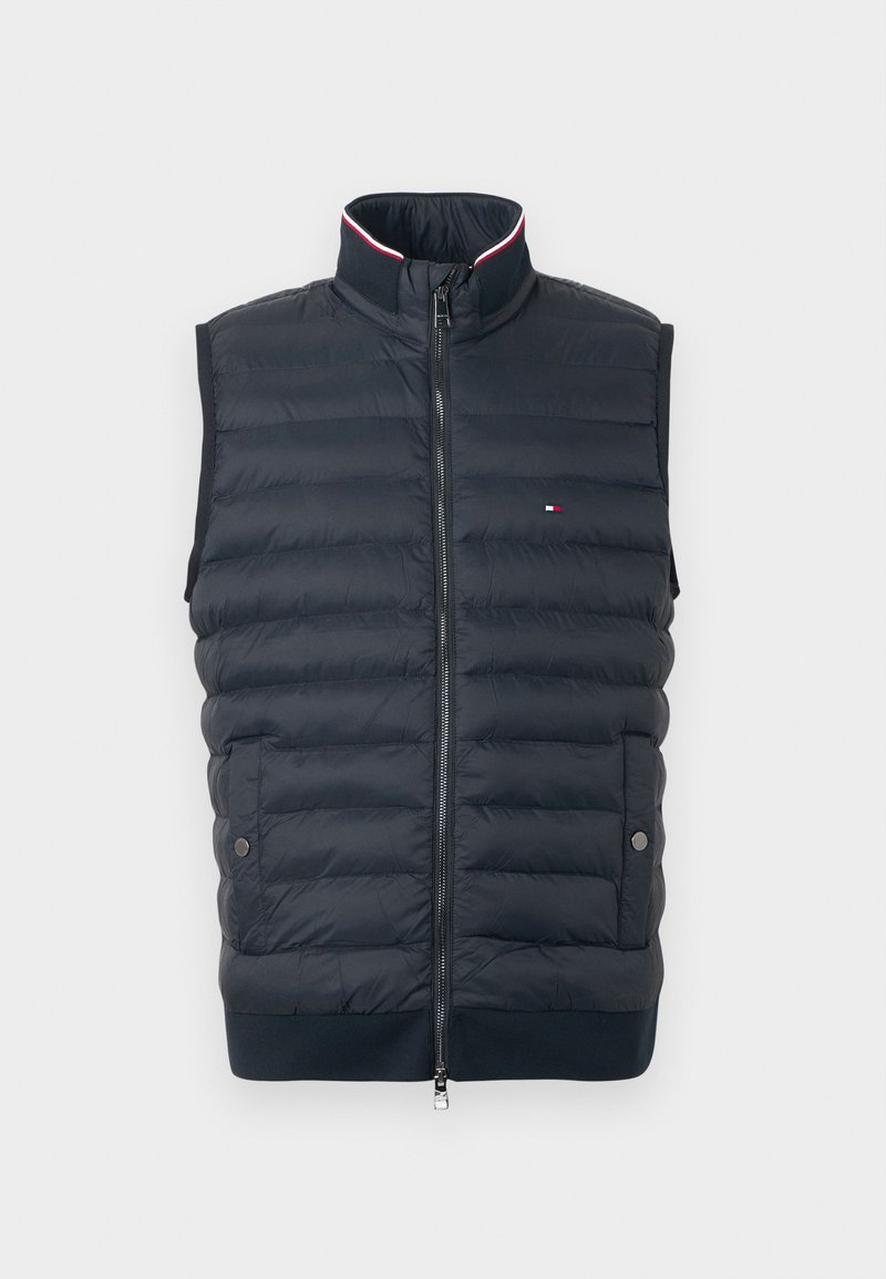 Marineblau gesteppte ärmellose Weste mit Stehkragen, Vorderreißverschluss, Druckknopf-Taschen und kleinem Flaggenlogo auf der Brust.