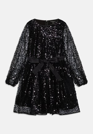 Black sequined dress with long sheer sleeves, a round neckline, and a satin belt tied at the waist, featuring a flared skirt design.