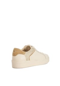 Beige leather sneaker with a textured suede heel accent and decorative shimmer detail on the side panel. Rounded toe and flat sole.