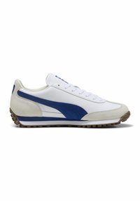 Sneaker de sport blanche avec des accents en daim et cuir bleu, semelle en caoutchouc texturée, fermeture à lacets à l'avant et col rembourré pour le confort.