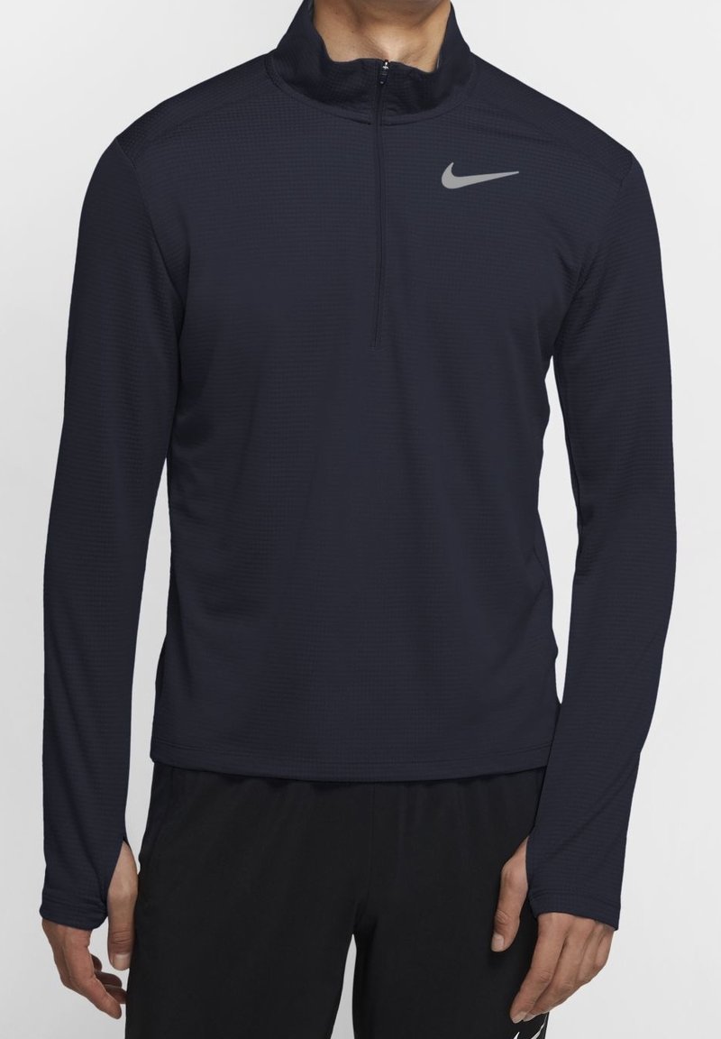 Dark blue long-sleeve athletic quarter-zip top with a textured fabric, featuring a gray Nike logo on the left chest.
