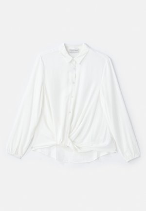 Weiße Bluse mit langen Ärmeln, kragenlosem Ausschnitt, Knopfverschluss und geknotetem Detail in der Taille. Hergestellt aus glattem, leichtem Stoff.