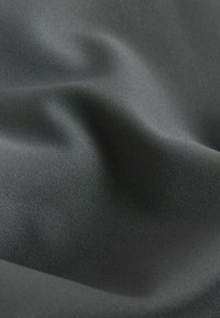 Black textile with a smooth, slightly reflective surface; features a subtle texture and soft draping appearance.