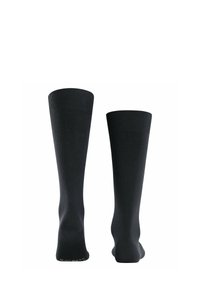 Calze nere fino al ginocchio con texture a costine e punta rinforzata. Presentano un bordo superiore liscio per una vestibilità sicura. Realizzate in materiale elasticizzato.