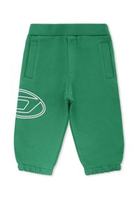 Groene joggingsbroek van zacht materiaal, met een elastische tailleband, zijzakken en een witte cirkelvormige grafiek op het linkervak.