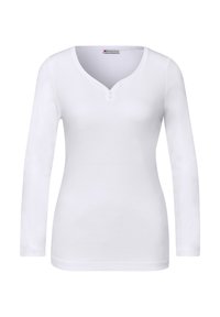 Witte top met lange mouwen gemaakt van katoen. Heeft een V-hals met twee knopen. Gladde textuur, aansluitend ontwerp en geen zichtbare patronen of accenten.