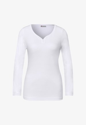 Witte top met lange mouwen gemaakt van katoen. Heeft een V-hals met twee knopen. Gladde textuur, aansluitend ontwerp en geen zichtbare patronen of accenten.