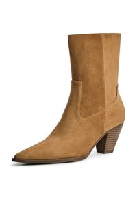 Tan suede ankle boot with a pointed toe, flat heel, and side cutout detail. Textured brown heel adds contrast to the smooth upper material.