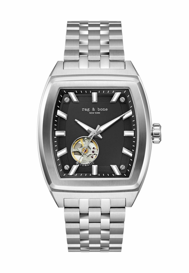 Ruudukujuline roostevabast terasest kell musta dials, hõbedased tunni näidikud ja avatud automaatne mehhanism. Metallist lingid.