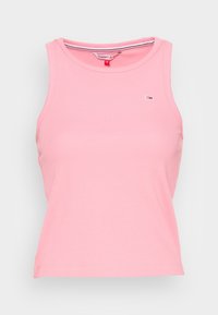 Różowy prążkowany top bez rękawów, krótki, z okrągłym dekoltem, z małym logo Tommy Jeans na piersi oraz z markową metką wewnętrznej kołnierzyka.