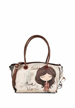 Beige und braune Handtasche mit Ledergriffen, ein Cartoon-Mädchen mit geschlossenen Augen und dem Text "Anekke time to bloom" auf der Vorderseite.