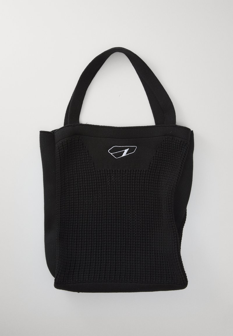 Black woven tote bag with two short handles, featuring a textured fabric and a small white logo on the front. Compact and structured design.