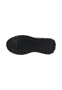 Suela de zapato de goma negra con un patrón de textura y surcos, así como acentos circulares para proporcionar agarre y estabilidad.
