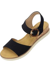 Czarne zamszowe sandały z odkrytymi palcami, z paskiem na kostce, korkowym obcasem w kształcie kotwicy i beżową, dobrze wyprofilowaną wkładką. Zawierają dekoracyjne elementy.