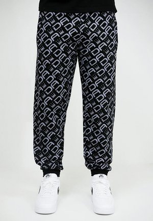 DADA, BAGGY DESIGN ALL OVER JOGGER MIT PRINT UND BÜNDCHEN - Trainingsbroek - schwarz