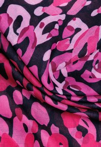 Pink and dark purple animal print fabric draped, featuring a mix of large and small abstract shapes with varying saturation and texture.