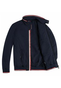 Veste bleu marine avec une bande rouge, blanche et bleue le long de la fermeture éclair et du col, ouverte pour montrer la poche intérieure et la doublure.