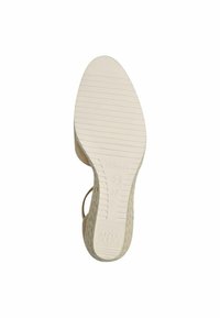 Suela de zapato beige con goma texturizada, presenta un patrón estriado para mayor agarre. Marcada con "ANTI SLIDE" y tamaño "37". Forma suave y redondeada.