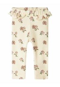 Leggings côtelés avec un motif floral dans des tons de rose doux et de vert sur un fond jaune pâle. Présentent une taille froncée et un ajustement élastique.