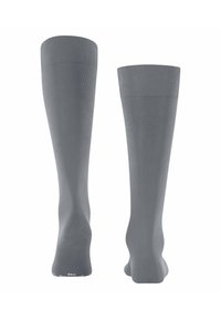 Calze grigie al ginocchio con texture a coste, realizzate in un materiale elastico. Presentano una punta senza cuciture e un polsino rinforzato per una maggiore durata.