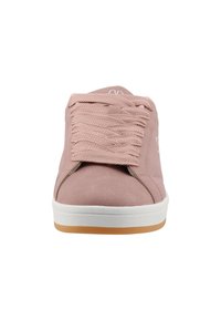 Pink suede sneaker with a textured surface, round toe, white rubber sole, and matching laces. Features a logo on the tongue.