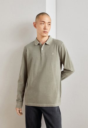 Langermet, olivengrønn polo-skjorte laget av myk bomull, med krage, tre knapper foran og liten logo brodert på brystet.