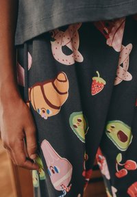 Bawełniana tkanina z bajkowymi ilustracjami jedzenia, takimi jak rogaliki, truskawki i rożki lodów na ciemnym tle.