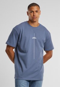 Gray cotton t-shirt with short sleeves, featuring a white text design "THINK DIFFERENT." centered vertically. Casual fit and simple texture.