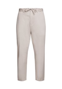 Pantalon beige clair à coupe large avec taille à cordon, doté d'une texture lisse et de poches latérales, se resserrant vers la cheville.