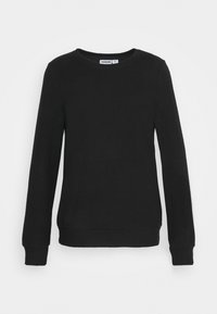 Svart stickad tröja gjord av mjukt material, med rund halsringning, långa ärmar och ribbade muddar och nederkant. Enkelt mönster utan mönster.