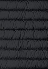Black puffer jacket fabric with quilted texture, featuring horizontal stitched sections and a smooth, shiny surface. No visible hardware.