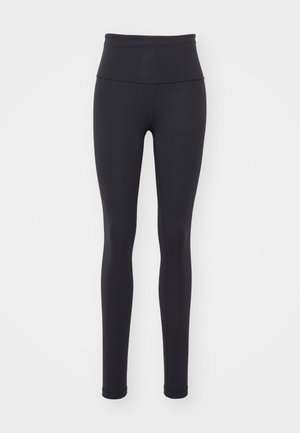 Zwarte high-waisted leggings gemaakt van rekbaar materiaal, met een geribbeld textuur en een aansluitend ontwerp zonder zichtbare patronen of hardware.