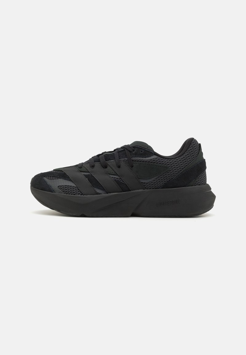 Black athletic shoes with a mesh upper, featuring black suede accents and three prominent stripes. Chunky sole for support and stability.