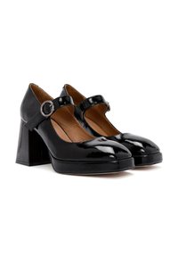 Chaussures à talons hauts en cuir verni noir avec un bout rond et une sangle Mary Jane maintenue par une boucle circulaire. Talons blocs épais.