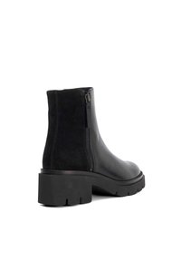 Black ankle boots featuring smooth leather and suede panels, a chunky rubber sole, and a side zipper for closure.